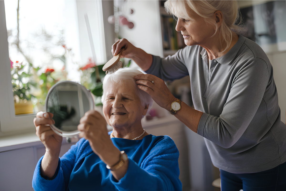 Home carer helping elderly woman with grooming and hair care at home in Nottingham Our carers help with every aspect of your daily routine, at your pace and with your comfort in mind.